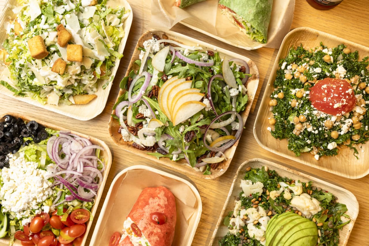 A selection of colorful salads displayed in small plates, showcasing a variety of ingredients and textures.